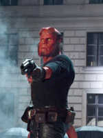 Hellboy standing on a car